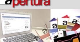 Computadora portatil a un lado de revistas apertura